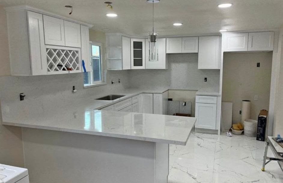 Completed white kitchen with marble countertops