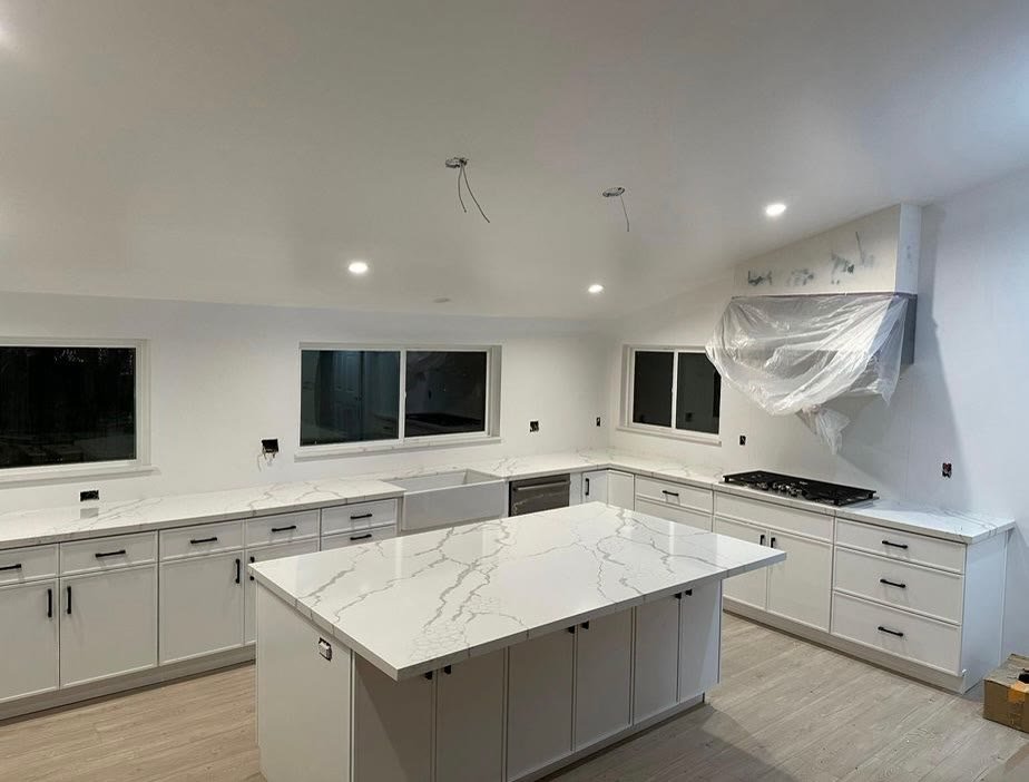 Completed large white kitchen with marble island