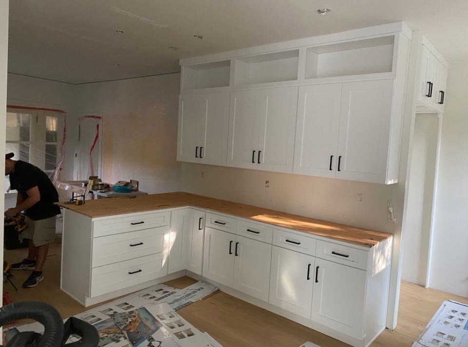 White cabinets with wood counters mid-install