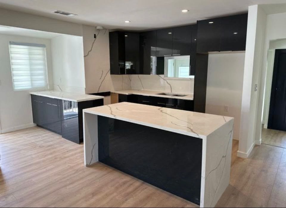Navy island with marble countertops mid-install